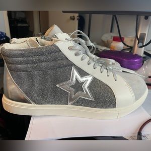 NWOT mid top white faux leather sneaker. Silver glitter and gray star on outside